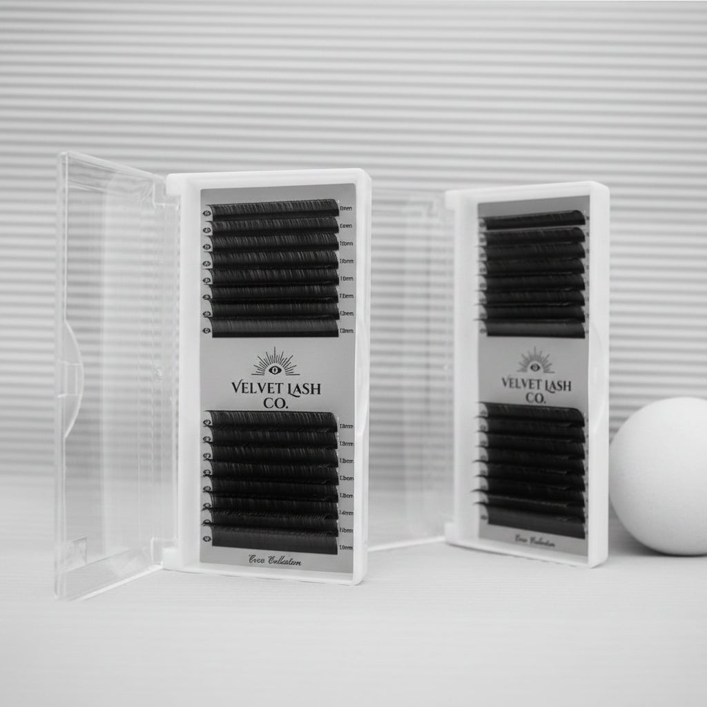 Two packages of Velvet Lash Co. false eyelashes on a pink background